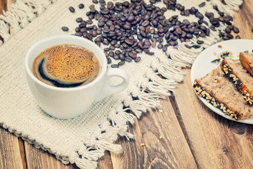 .Cup of coffee with biscuits on a wooden table.Focus concept.