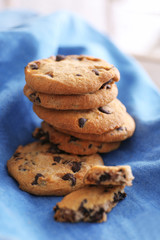 Fresh oat biscuits with chocolate on napkin, closeup