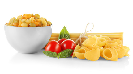 Different kinds of dry pasta with tomatoes, isolated on white