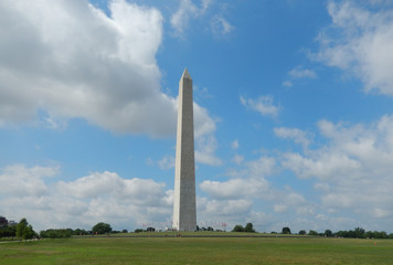 The Washington Monument obelisk landmark against a cloudy sky on the National Mall in Washington...