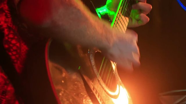 Guitarist Plays Guitar in Night Club against Light Flashes