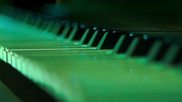 Closeup Electric Piano Keys under Flashes of Colourful Lights