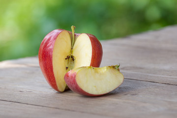 red apple on table outdoors.