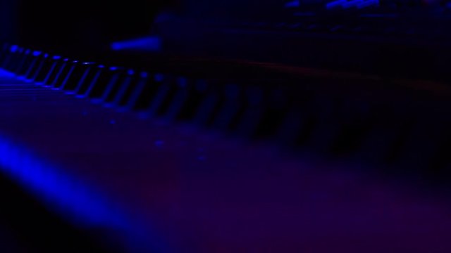 Closeup Electric Piano Keys under Flashes of Colourful Lights