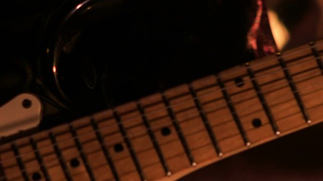 Closeup Guitarist Touches Strings on Finger-board in Night Bar