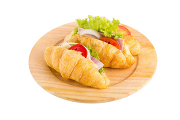 croissant sandwich ham on wooden plate