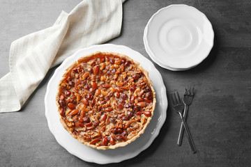 Delicious cake with nuts on table