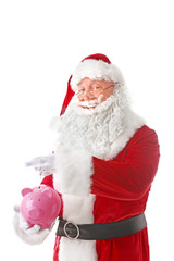 Santa Claus putting coin into piggy bank on white background