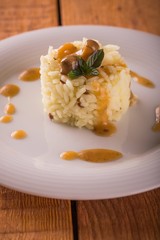 White plate with sesame rise and green mint herb