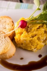 Young radish on scrambled eggs with leaves