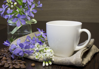 Coffee and spring flowers on old wooden table