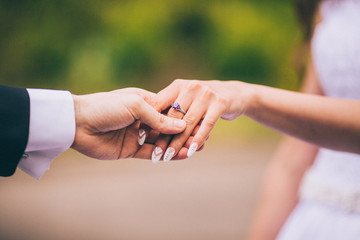 Bride and groom holding hands outdoors