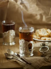 Keuken foto achterwand Thee Glass of tea  in Soviet style glass holder