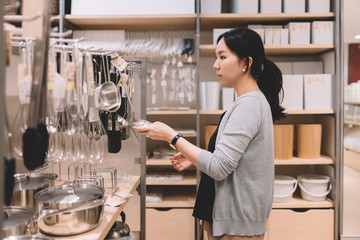 Asian woman shopping for kitchenware