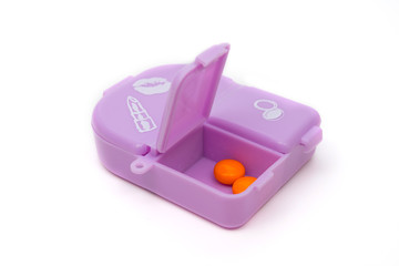 a pink pillbox , isolated background