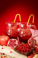 Fototapeta na wymiar Pomegranate juice with red background