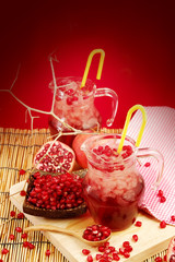 Pomegranate juice with red background
