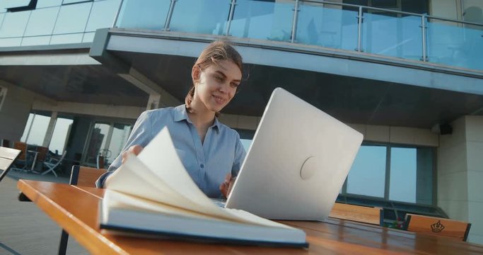 Beautiful girl in business clothes corresponds with the client
