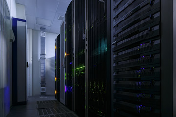 room with rows of server hardware in data center