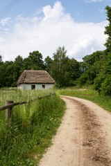 dirt road and a small house