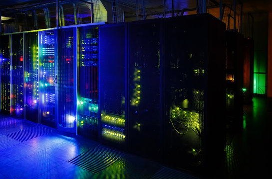 server room in the dark, with bright colored lights