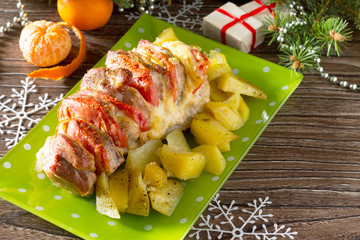 Baked meat with cheese and tomato with baked potato on a festive