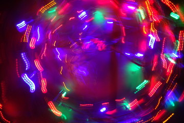 Chaotic lights in moriol blur out of focus - abstract photograph background.