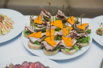 Beautifully decorated catering banquet table with different food snacks and appetizers on corporate christmas birthday party event or wedding celebration
