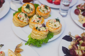 Beautifully decorated catering banquet table with different food snacks and appetizers on corporate christmas birthday party event or wedding celebration
