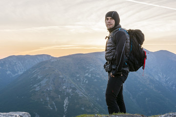 Hiker with backpack with a sunrise.