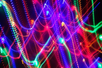 Chaotic lights in moriol blur out of focus - abstract photograph background.