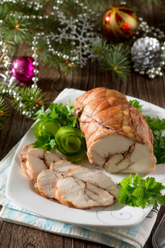 Roll of chicken, baked meat with red wine on the festive Christm