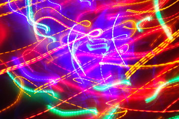 Chaotic lights in moriol blur out of focus - abstract photograph background.
