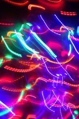 Chaotic lights in moriol blur out of focus - abstract photograph background.