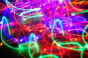 Chaotic lights in moriol blur out of focus - abstract photograph background.