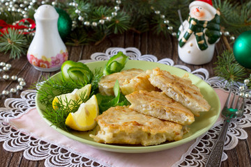 Fried fish in batter potato on a wooden Christmas table.