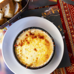 Baked traditional rustic Italian style lasagna in a clay pot..