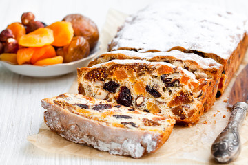 homemade  cake with dried fruits on white wooden table