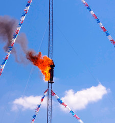 Fire Diver Daredevil preparing to jump off a high dive platform into a pool of water. Stuntman...