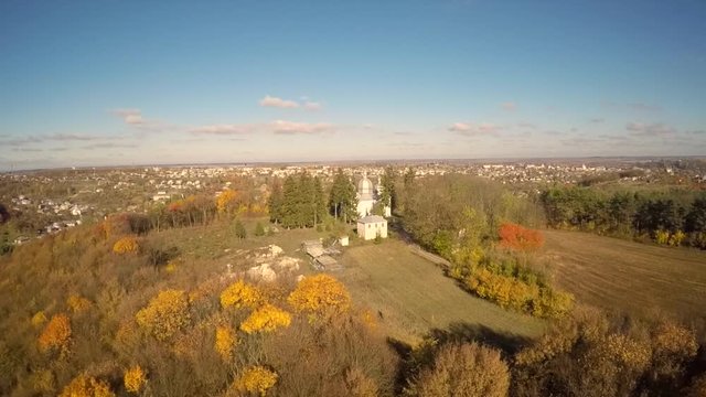 A bird's eye view of a church in the woods