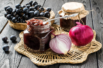 Obraz na płótnie Canvas Onion jam with grapes in glass jars