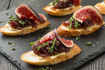 Canape with cheese, onion jam, figs and thyme
