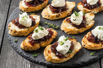 Canape with onion jam, cream cheese and thyme