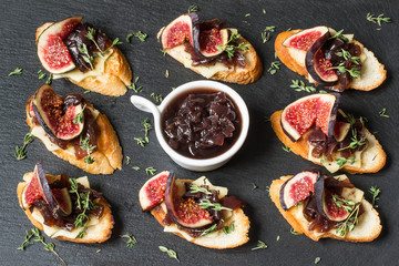 Canape with cheese, onion jam, figs and thyme