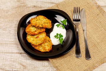 Potato pancakes with sour cream and parsley