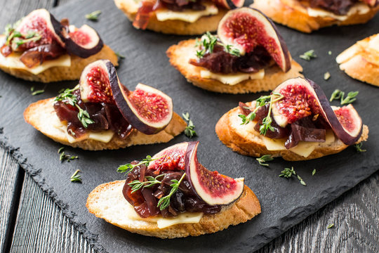 Fototapeta Canape with cheese, onion jam, figs and thyme
