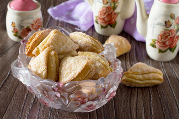 Cookies from puff pastry (shortcrust pastry with cheese) on a wo
