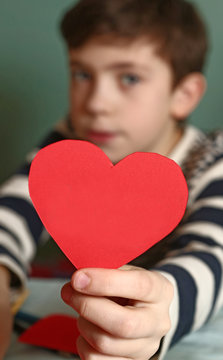 handsome boy with valentine red paper heart