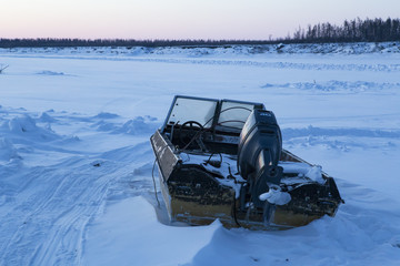 Motor boat in the snow. Indigirka River, Yakutia, Russia.