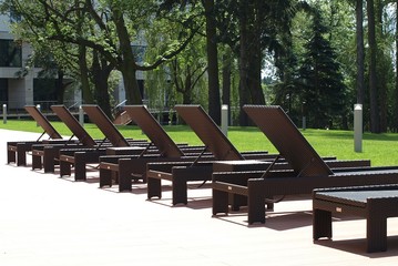 Brown sunbeds at sunset times